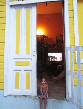 A child sits in the doorway of a house in Casco Viejo.