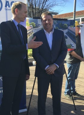 Capital Metro Minister Simon Corbell with Canberra Metro consortium chief executive Martin Pugh on Tuesday. Can the Tram protester David Dickson is in the background.