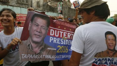 Supporters hold a campaign banner of presidential candidate Mayor Rodrigo Duterte in Manila, the Philippines. 