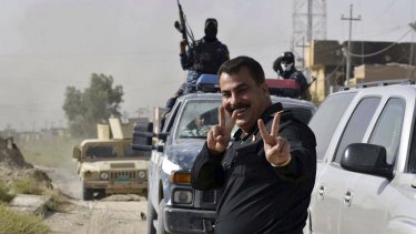 Iraqi security forces celebrate in central Fallujah, Iraq, after fighting against the Islamic State militants.