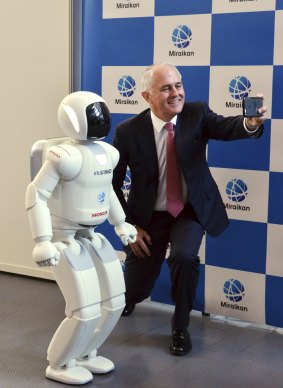 The PM with a humanoid robot during a visit to Japan in December.
