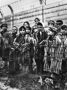 Children behind a barbed wire fence at the Nazi concentration camp at Auschwitz in southern Poland. 