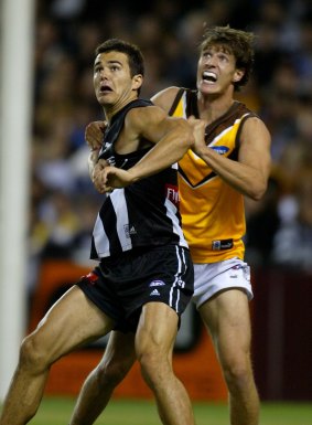 Stone played for Hawthorn, Collingwood and St Kilda during his AFL career. Here Collingwood's Chris Tarrant waits for the ball while being held by Stone.