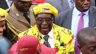 Zimbabwean President Robert Mugabe, centre, arrives for a solidarity rally in Harare last week.