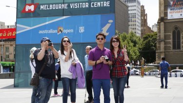 A group of Chinese tourists take in the sights around Federation Square, Melbourne. 