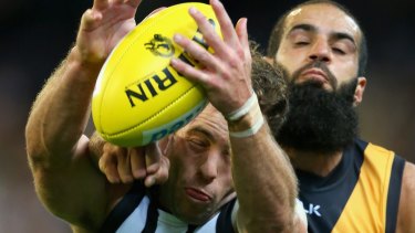 Bachar Houli, of the Tigers, and Jarryd Blair, of the Magpies, during Friday night's controversial game.