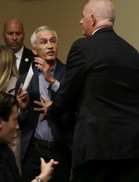 A security guard for Republican presidential candidate Donald Trump removes Miami-based Univision anchor Jorge Ramos from a news conference in Iowa. 