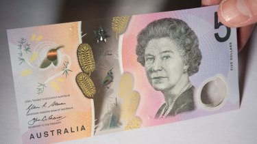 Some machines are spitting out the new $5 note. 
