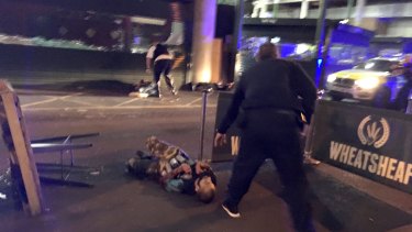 One of the suspects lying on the ground after being shot by police outside Borough Market in London.