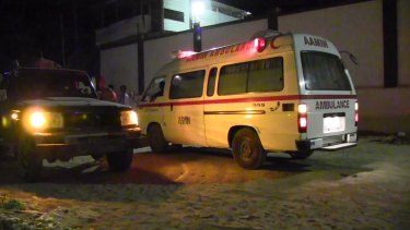 An ambulance waits near the scene of an attack in a restaurant in Mogadishu on Wednesday.