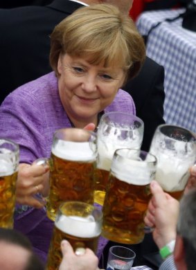 Angela Merkel raises a glass at a traditional folk festival in southern Germany on 2012.