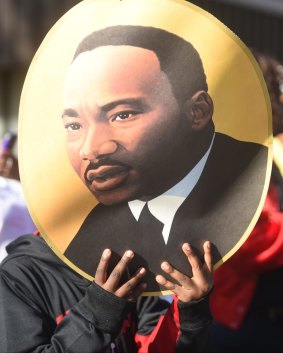 Catalyst: An activist carries a picture of Martin Luther King jnr during an event in Chattanooga, Tennessee.