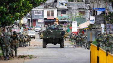 Philippine marines walk to the frontline in the continuing assaults to retake control of some areas of Marawi.