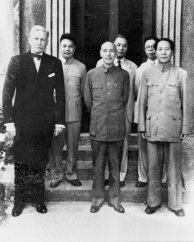 In this 1945 photo, China's Nationalist President Chiang Kai-shek, centre, and his Communist rival Mao Zedong, right, stand together with US ambassador to China Patrick Hurley in Chongqing, China.