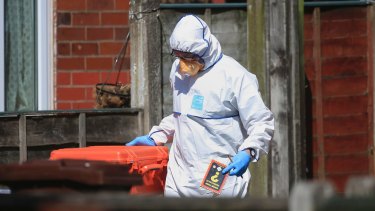 Police forensic investigators search the property of Salmon Abedi.