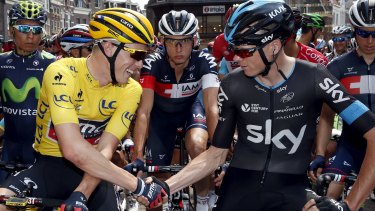 BMC's Australian rider Rohan Dennis shakes hands with Team Sky leader Chris Froome before the start of stage 2 in Utrecht.