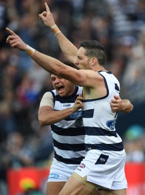 Steven Motlop (left) and Harry Taylor of the Cats react after Taylor kicked a goal.