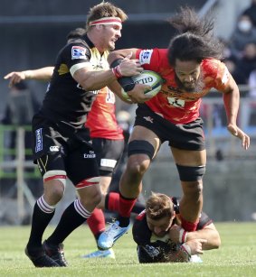 Trapped: Leak Moli tries to make a break for the Sunwolves but is tackled by Lions opponent Jaco Kriel.