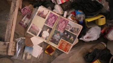A family photo album in the rubble of a home in Sinjar.