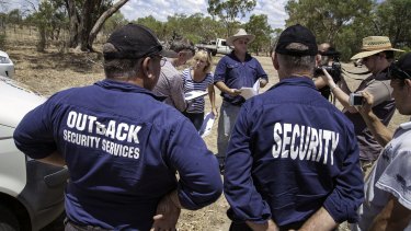 A security team evicts Claire (striped shirt) and Chris (blue shirt) Priestley from a north-west NSW property owned by their family since 1969.