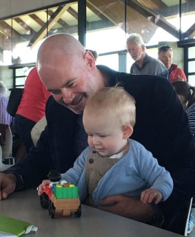 Anthony Toms, partner of Andrew Barr, entertains Andrew Barr's nephew, Angus, 10 months.