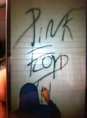 A young Gold Coast man has confessed to spray painting "Pink Floyd" on the wall of a Gold Coast school.