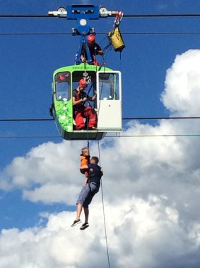 Firefighters rescue people from the a cable car gondola in Cologne, Germany, on Sunday.