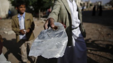 A man displays a bomb fragment from a house destroyed by an air strike of the Saudi-led coalition in Sanaa, Yemen, earlier this month.