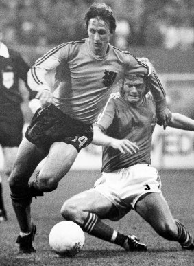 Cruyff, left, dodges the tackle from Sweden's Kent Karlsson during a World Cup soccer match  in 1974. 