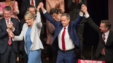 Opposition Leader Bill Shorten links hands with Tanya Plibersek and Chris Bowen at the campaign launch.