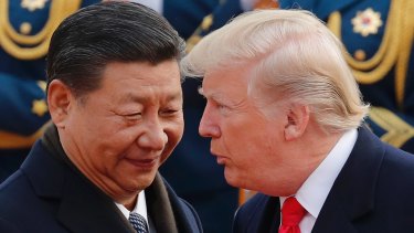 President Donald Trump, right, chats with Chinese President Xi Jinping during a welcome ceremony at the Great Hall of the People in Beijing on November 9.