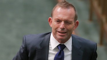 Former prime minister Tony Abbott winks as he departs Question Time.