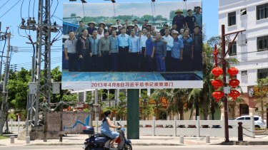 A poster of Chinese President Xi Jinping with local fishermen at the entrance of the port of Tanmen.
