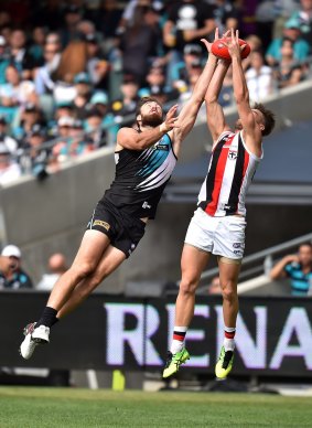 Aerial battle: Charlie Dixon of the Power competes with Sam Fisher of the Saints.