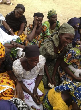 Mothers of kidnapped girls weep on the grounds of the burned-out ruins of Chibok Government Girls Secondary School in northern Nigeria in May 2014. 