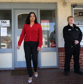 Dr Mehreen Faruqi leaves the Fertility Control Clinic in Albury, where a security guard is stationed.
