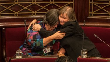 Greens MP's Colleen Hartland and Samantha Dunn embrace after the voluntary assisted dying laws pass the upper house.