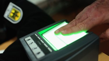 A migrant gives his finger print at a processing centre in Passau, Germany. German police only allow migrants to enter who say they will apply for asylum in Germany. Those who say they want to continue to other countries, such as Denmark or Sweden, are denied entry and brought back to Austria. 