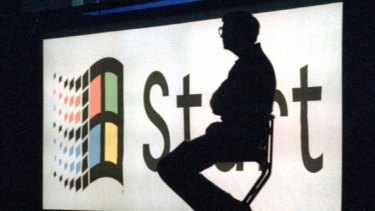 Bill Gates sits on stage during a portion of the Windows '95 launch  event in 1995.