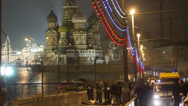 Russian police investigate the the body of Boris Nemtsov, a former Russian deputy prime minister and opposition leader at Red Square with St Basil Cathedral in the background in Moscow, Russia.