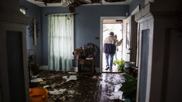 Lucas Garcia walks out of his home in Refugio, Texas. His family rode out Hurricane Harvey in a single room in their home.