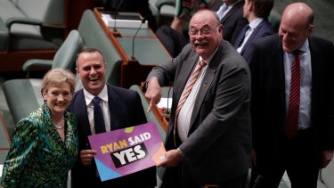 Liberal MPs Jane Prentice, Tim Wilson and Warren Entsch hold up a sign saying "Ryan said yes".