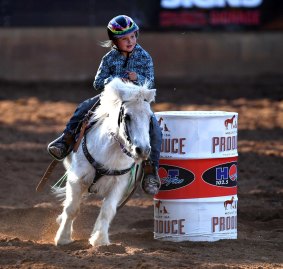 Seven-year-old Dekota Caban competes in the Junior Barrel Racing competition at the Mt Isa Rodeo.