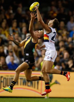 The Tigers' Brandon Ellis competes for the ball with the Crows' Rory Atkins at Etihad Stadium on Saturday. 