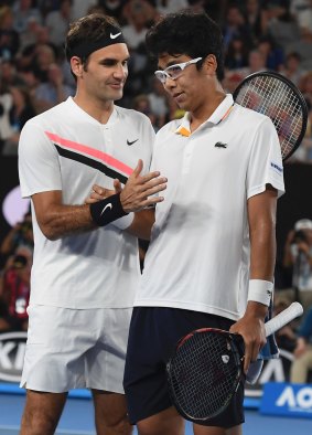 Federer and Chung shake hands after the South Korean retired hurt.