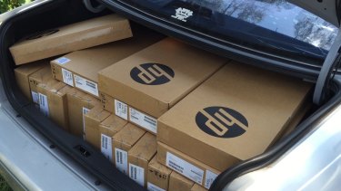 A car boot full of new laptops ready for delivery for new vocational students.