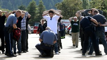 Police search students outside Umpqua Community College in Roseburg, Oregon.
