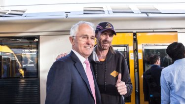 Before catching a train to the city, Prime Minister Malcolm Turnbull gets the thumbs up from a man at Central Station.