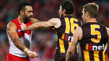 Rough night: Sydney's Adam Goodes challenges Isaac Smith of the Hawks at ANZ Stadium on Saturday night.