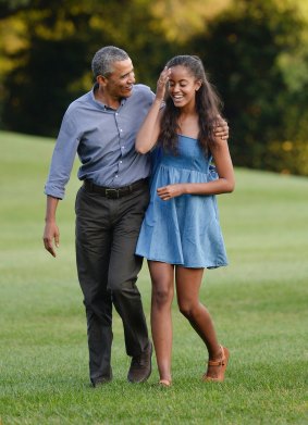 US President Barack Obama (L) and daughter Malia arrive at the White House in Washington, D.C on August 23, 2015.